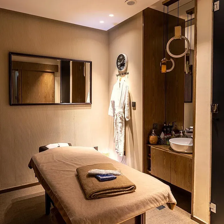 Private treatment room with robe and basin at RuSpa Dubai